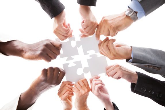 close up photo of business people holding jigsaw puzzle